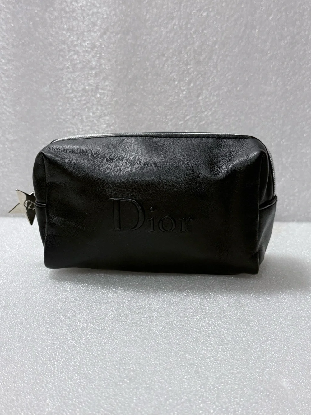 Dior makeup bag features a black exterior